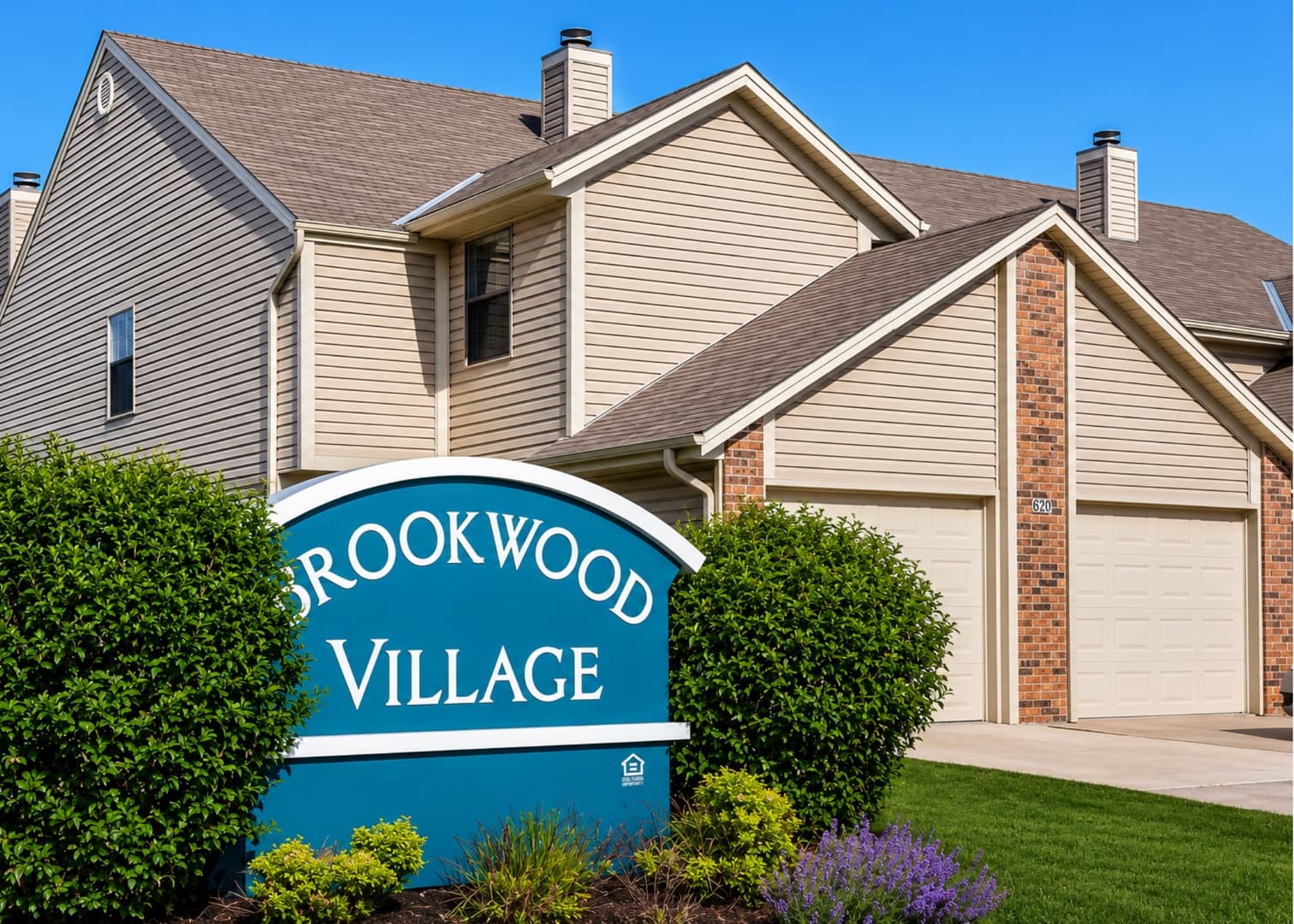 Brookwood Village entrance sign with townhomes behind